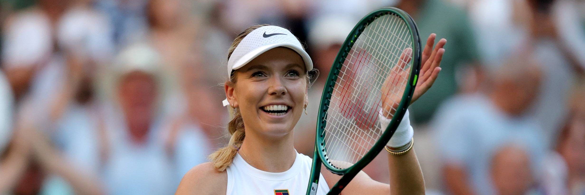 Katie Boulter smiles and claps the crowd after a first round win at Wimbledon