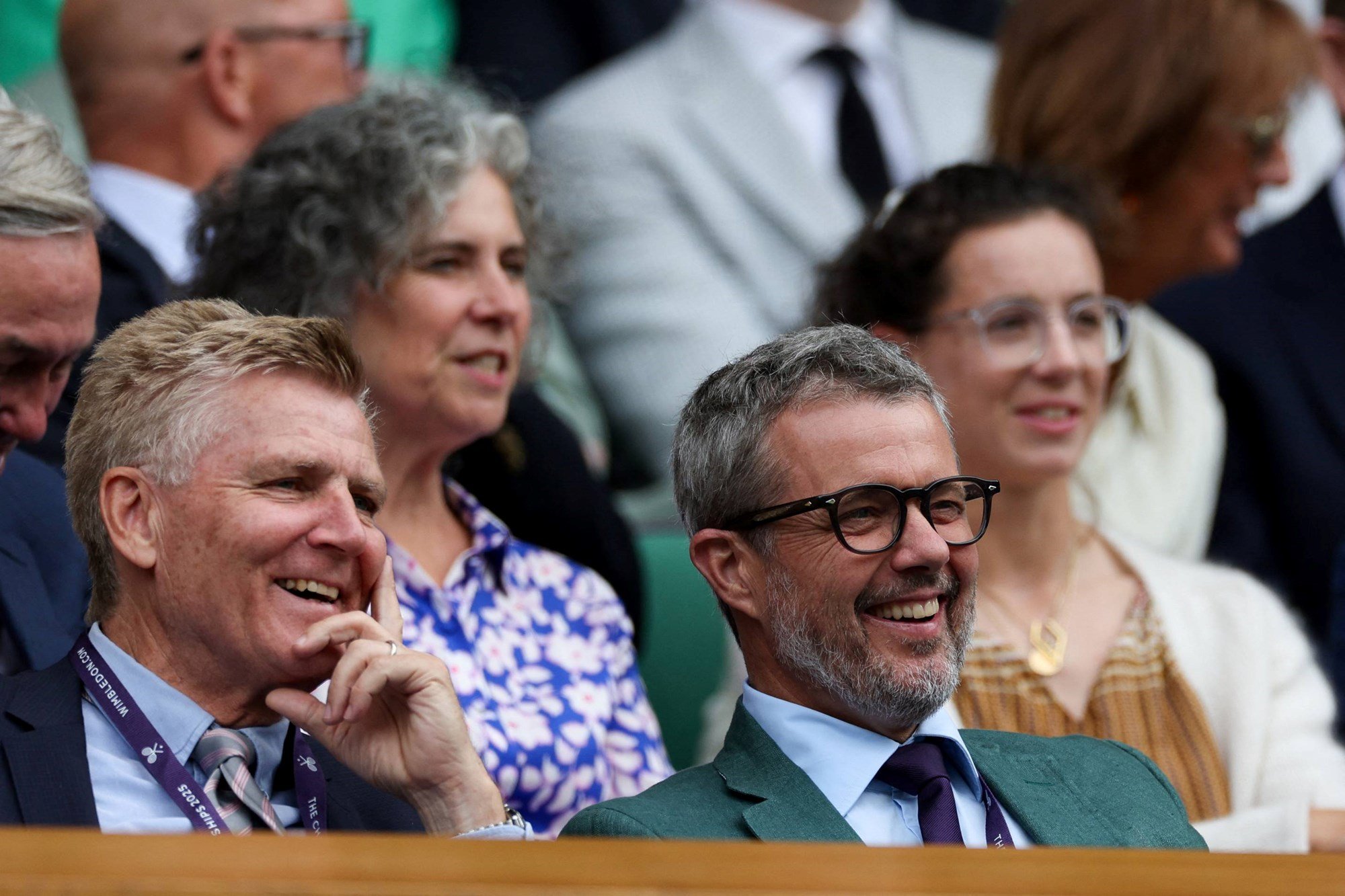 Frederik X, King of Denmark laughing as he enjoys the tennis from the Royal Box at Wimbledon