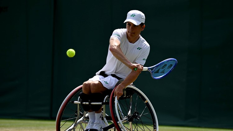 Greg Slade lines up a backhand in the quad singles at Wimbledon