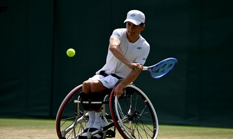 Greg Slade lines up a backhand in the quad singles at Wimbledon