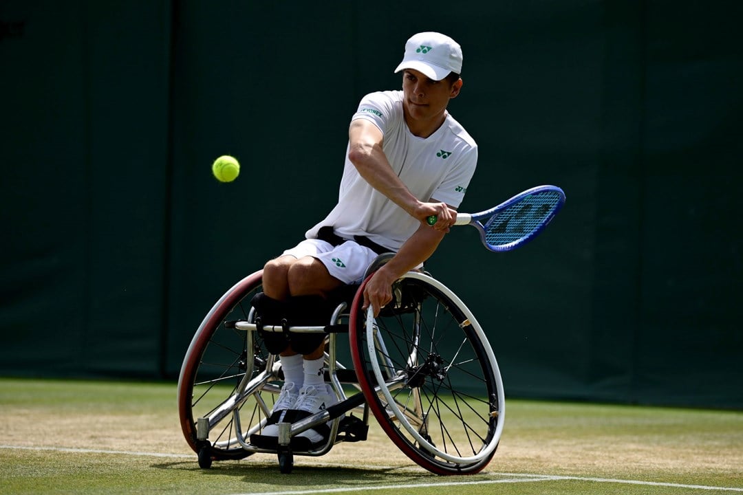 Greg Slade lines up a backhand in the quad singles at Wimbledon