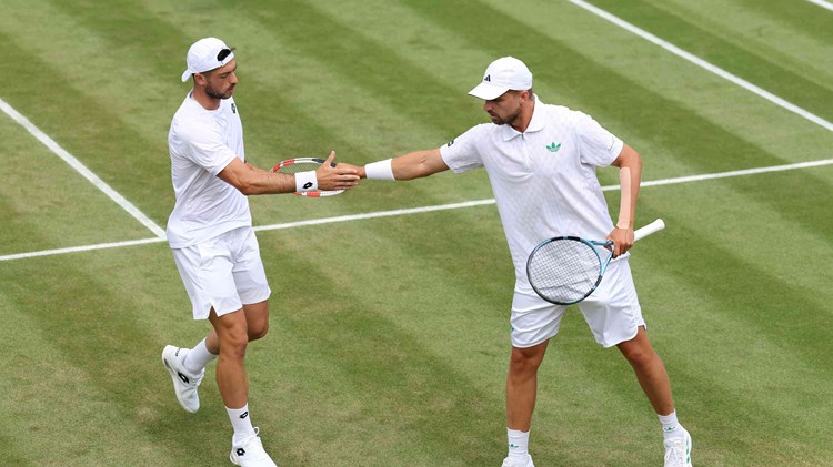 Julian Cash and Lloyd Glasspool high five in the third round at Wimbledon