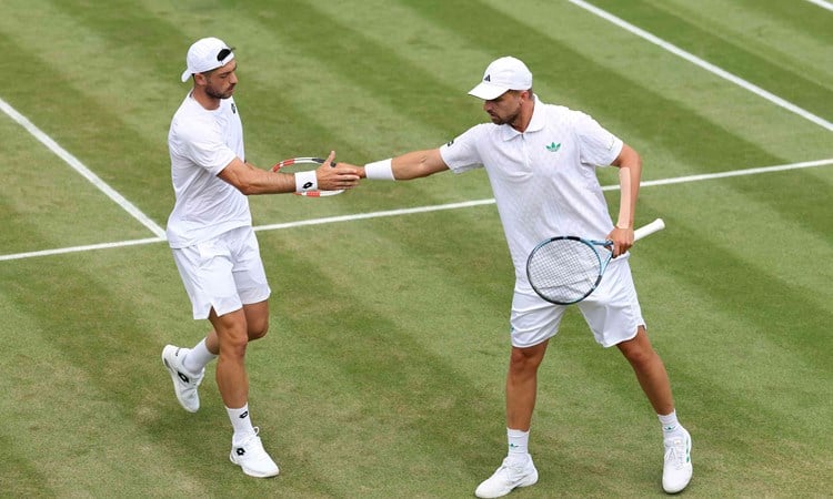 Julian Cash and Lloyd Glasspool high five in the third round at Wimbledon
