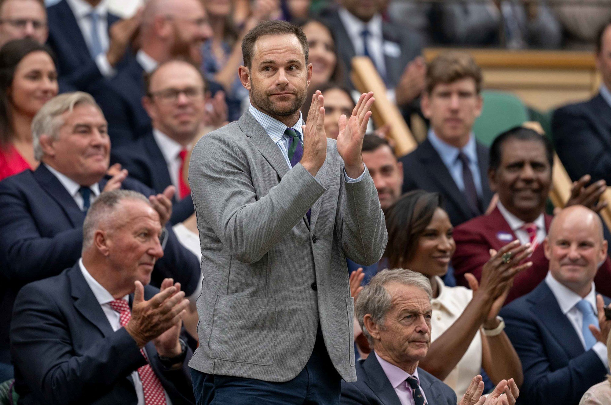 Former Wimbledon runner-up Andy Roddick stands and applauds on Centre Court at Wimbledon