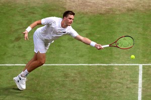Henry Patten stretching for a forehand volley in the Wimbledon semi-finals