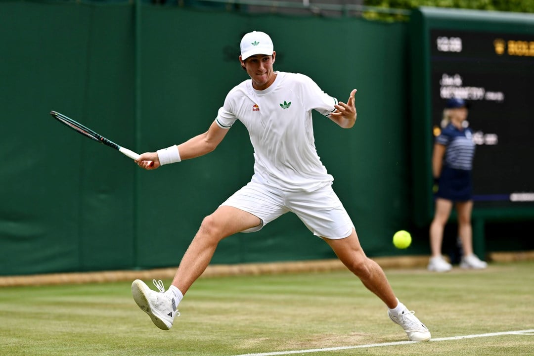 Oliver Bonding hitting a forehand on court at Wimbledon