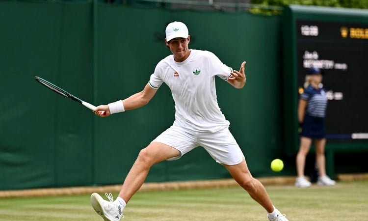 Oliver Bonding hitting a forehand on court at Wimbledon