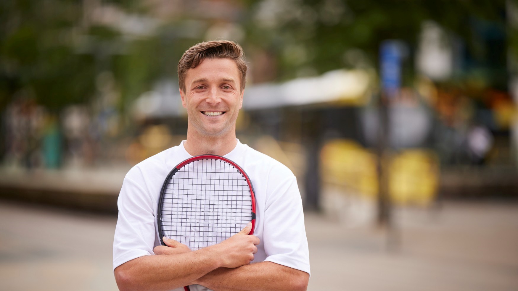 Liam Broady standing in Manchester city centre to promote the Davis Cup Finals at the Manchester AO Arena