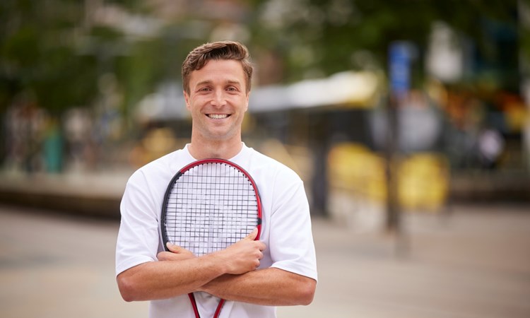 Liam Broady standing in Manchester city centre to promote the Davis Cup Finals at the Manchester AO Arena