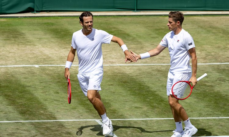 Neal Skupski and Wesley Koolhof high five in the Wimbledon men's doubles quarter-finals