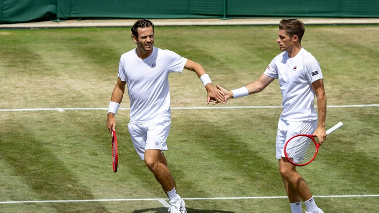 Neal Skupski and Wesley Koolhof high five in the Wimbledon men's doubles quarter-finals