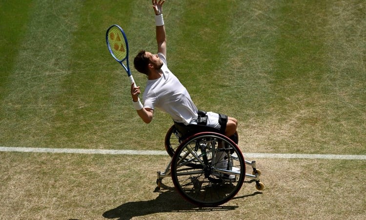 Alfie Hewett hits a serve during the final of the men's wheelchair singles at Wimbledon