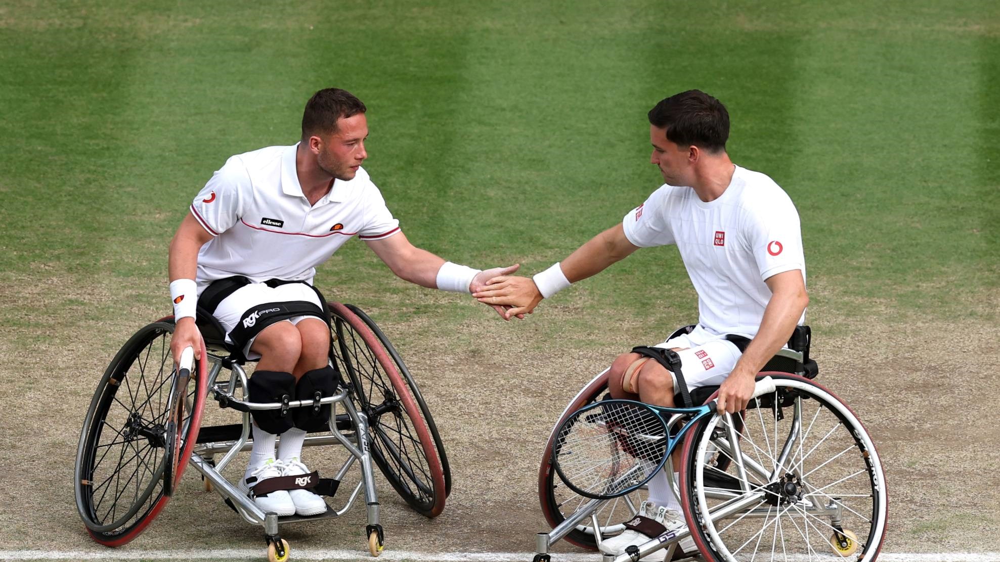 Alfie Hewett and Gordon Reid high five during doubles action at Wimbledon