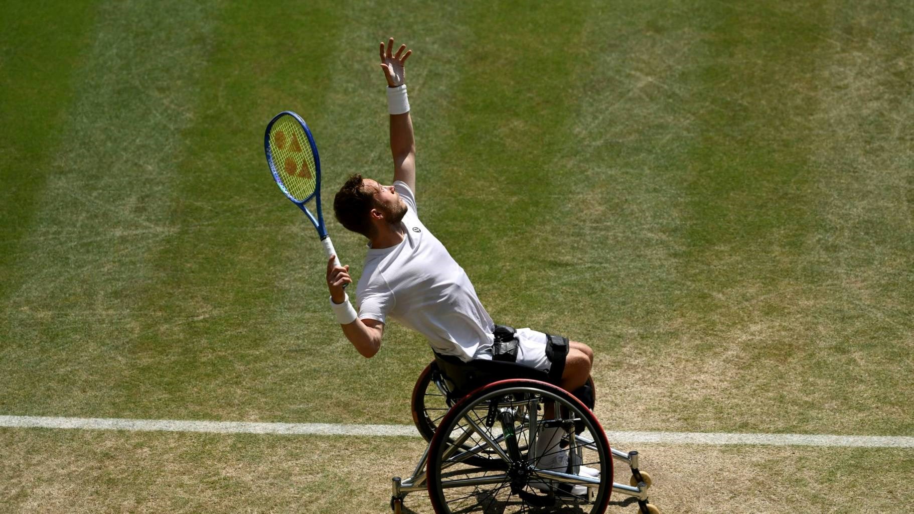 Alfie Hewett hits a serve during the final of the men's wheelchair singles at Wimbledon
