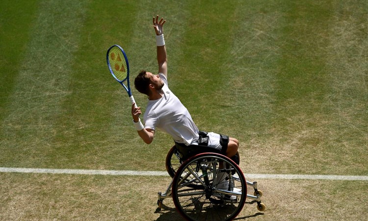 Alfie Hewett hits a serve during the final of the men's wheelchair singles at Wimbledon