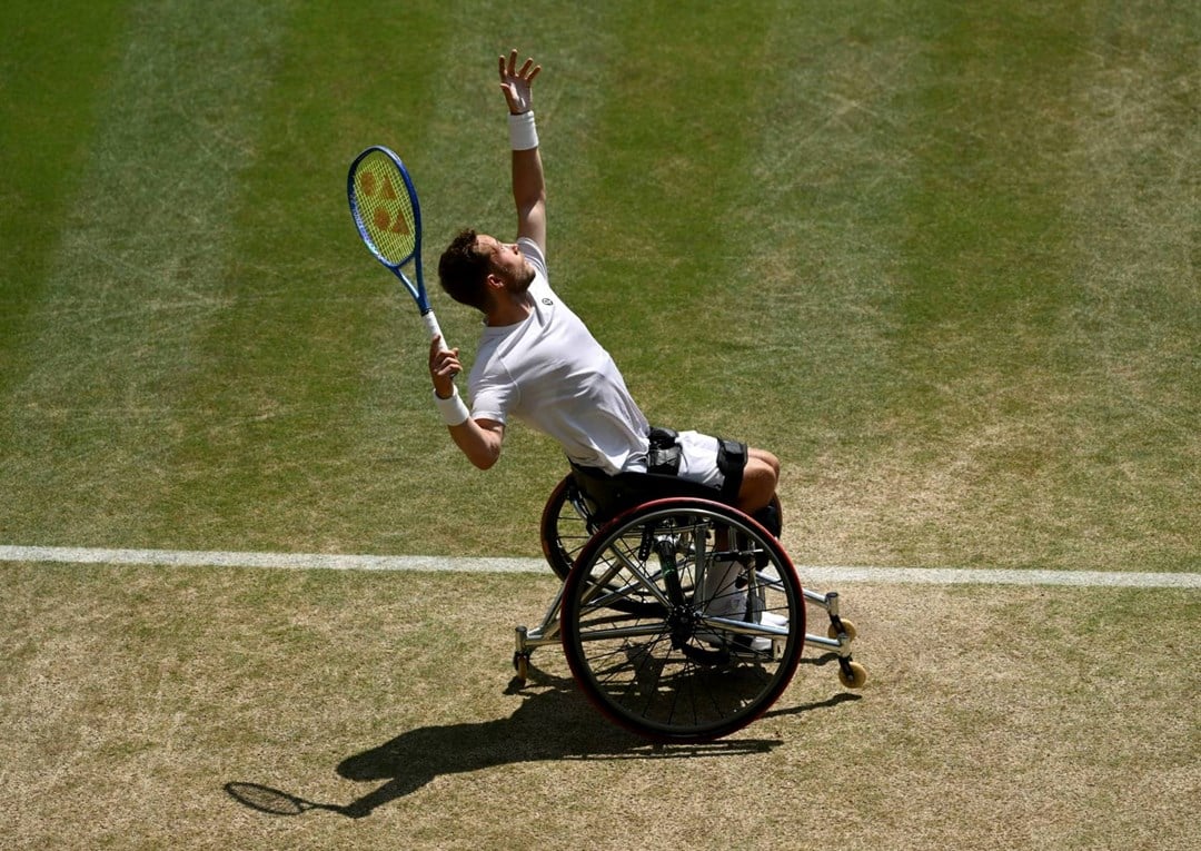 Alfie Hewett hits a serve during the final of the men's wheelchair singles at Wimbledon