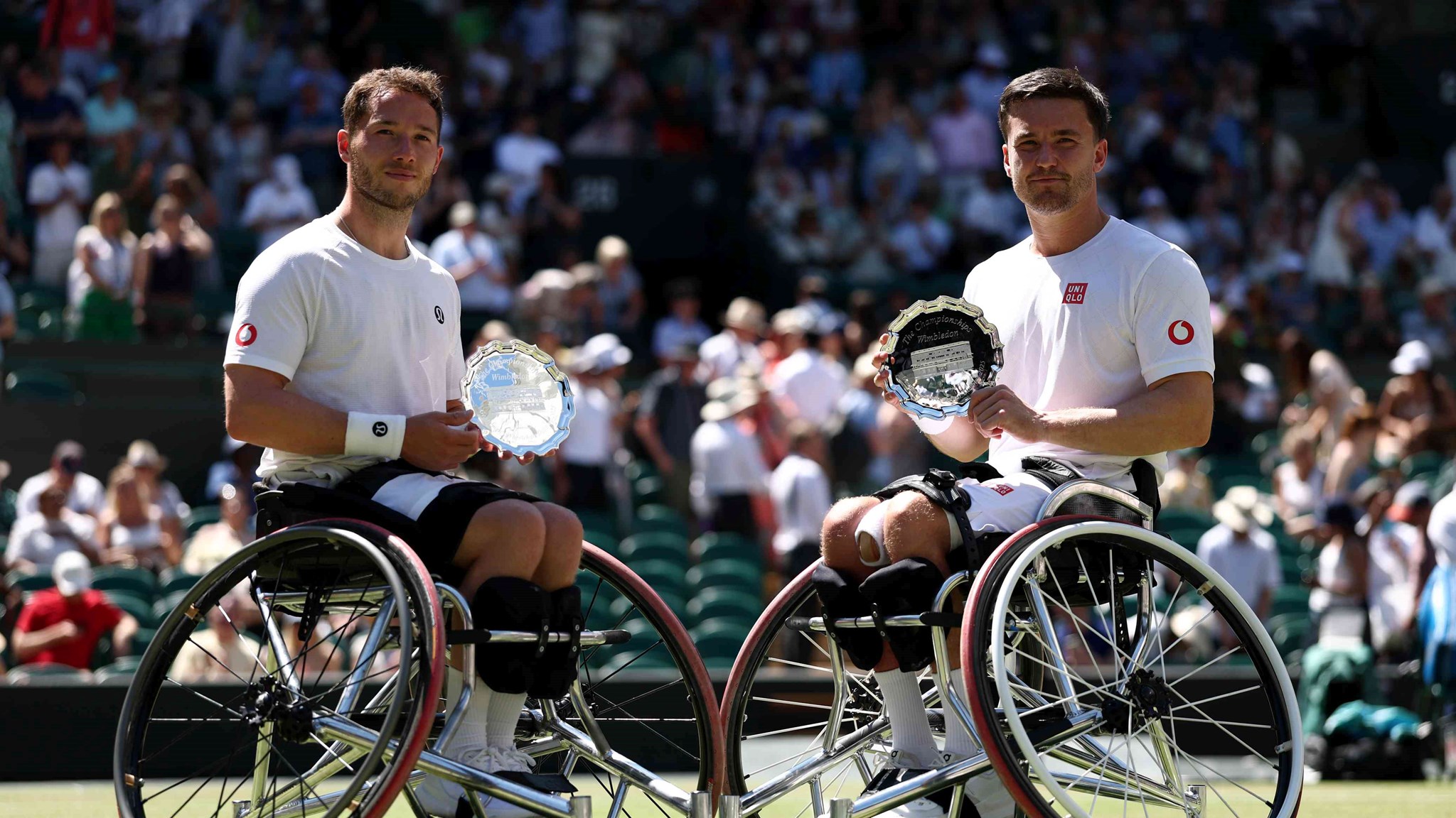 Alfie Hewett and Gordon Reid smiling with their Wimbleodn  men's wheelchairdoubles runner-up trophies