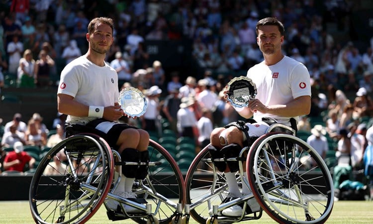 Alfie Hewett and Gordon Reid smiling with their Wimbleodn  men's wheelchairdoubles runner-up trophies