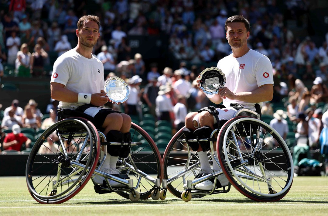 Alfie Hewett and Gordon Reid smiling with their Wimbleodn men's wheelchairdoubles runner-up trophies