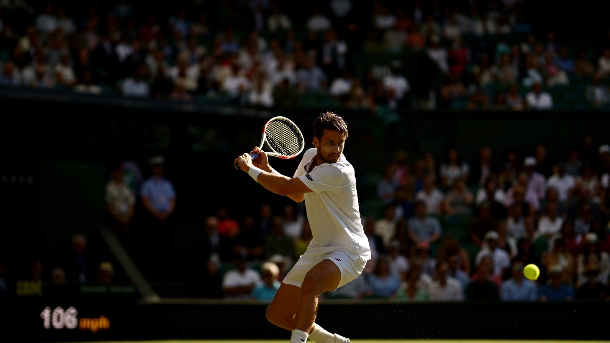 Cam Norrie about to hit a back hand in front of the Wimbledon crowd