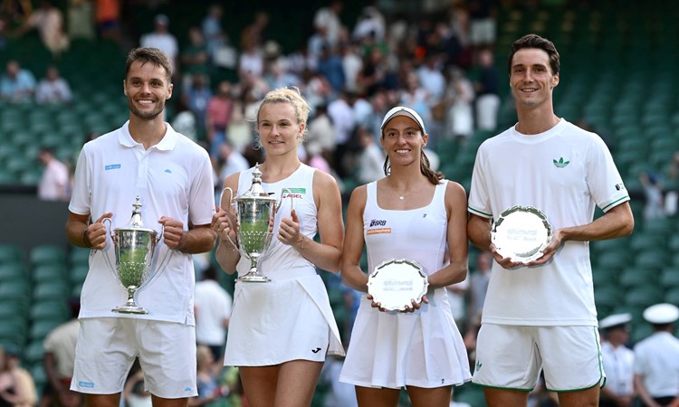 Joe Salisbury and Luisa Stefani smile while holding up their Wimbledon mixed doubles trophies next to  Sem Verbeek and  Katerina Siniakova who are holding up the champions trophy