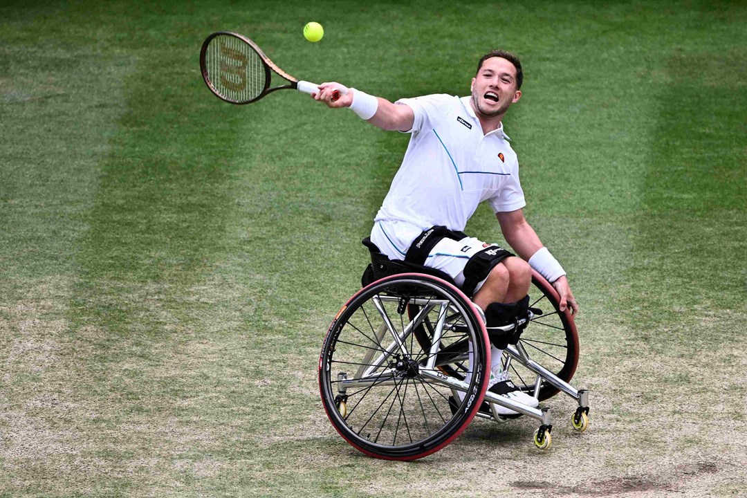 Alfie Hewett sitting in his wheelchair about to hit a forehand on court at the Wimbledon final