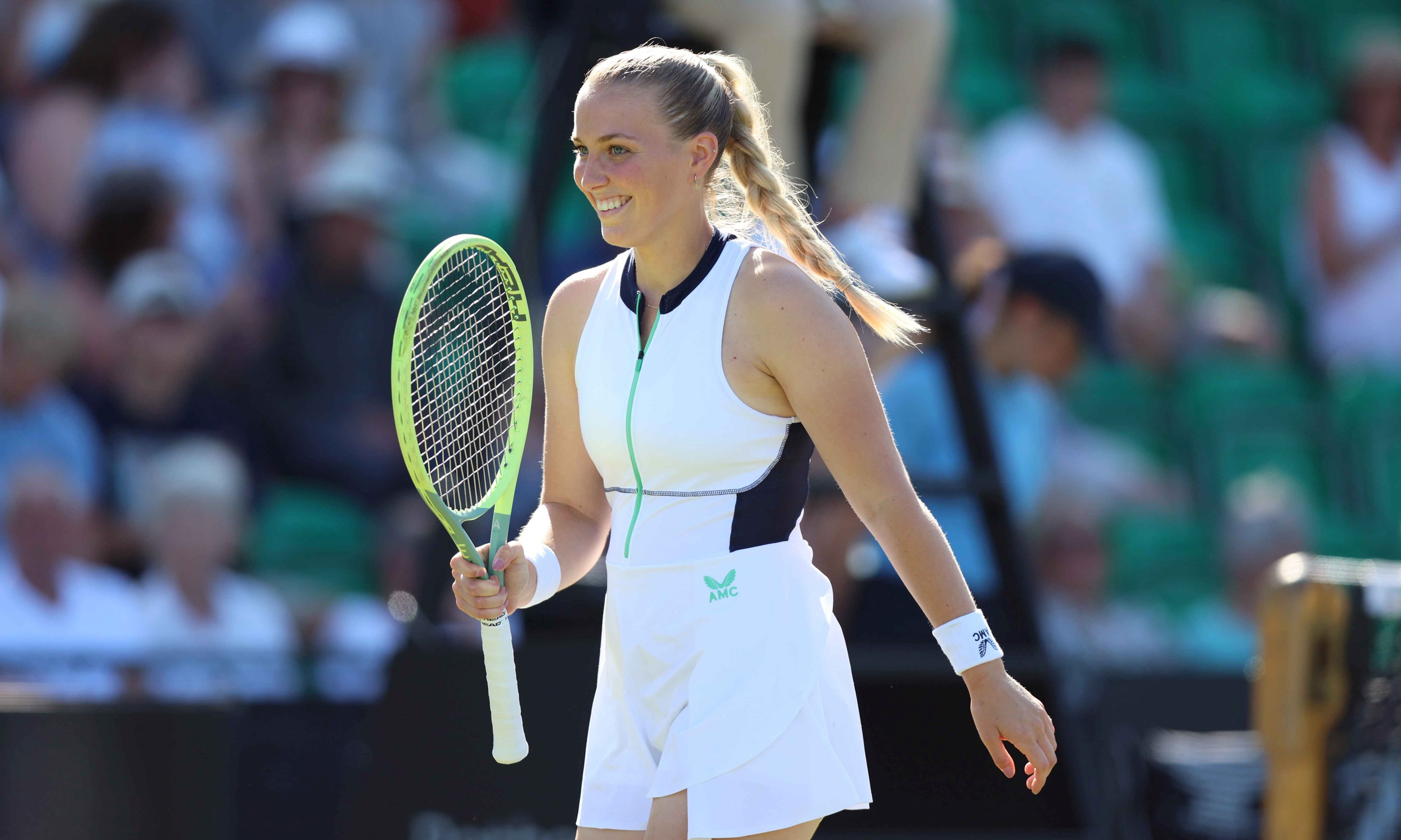 An image of Ali Collins holding her racket up on court