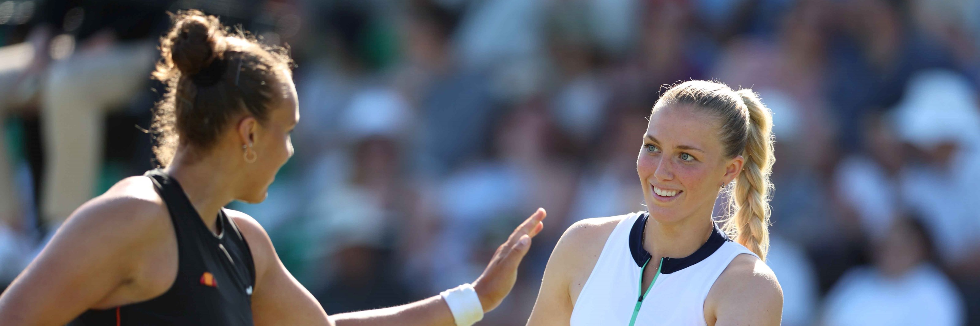 Ali Collins high-fiving doubles partner Freya Christie on court 