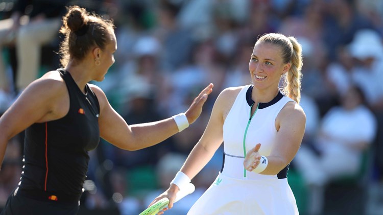 Ali Collins high-fiving doubles partner Freya Christie on court 