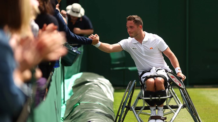 Alfie Hewett shakes hands with the crowd after winning match point against Gordon Reid during their Men's Wheelchair singles Quarter-Finals on day eleven of The Championships Wimbledon 2022 