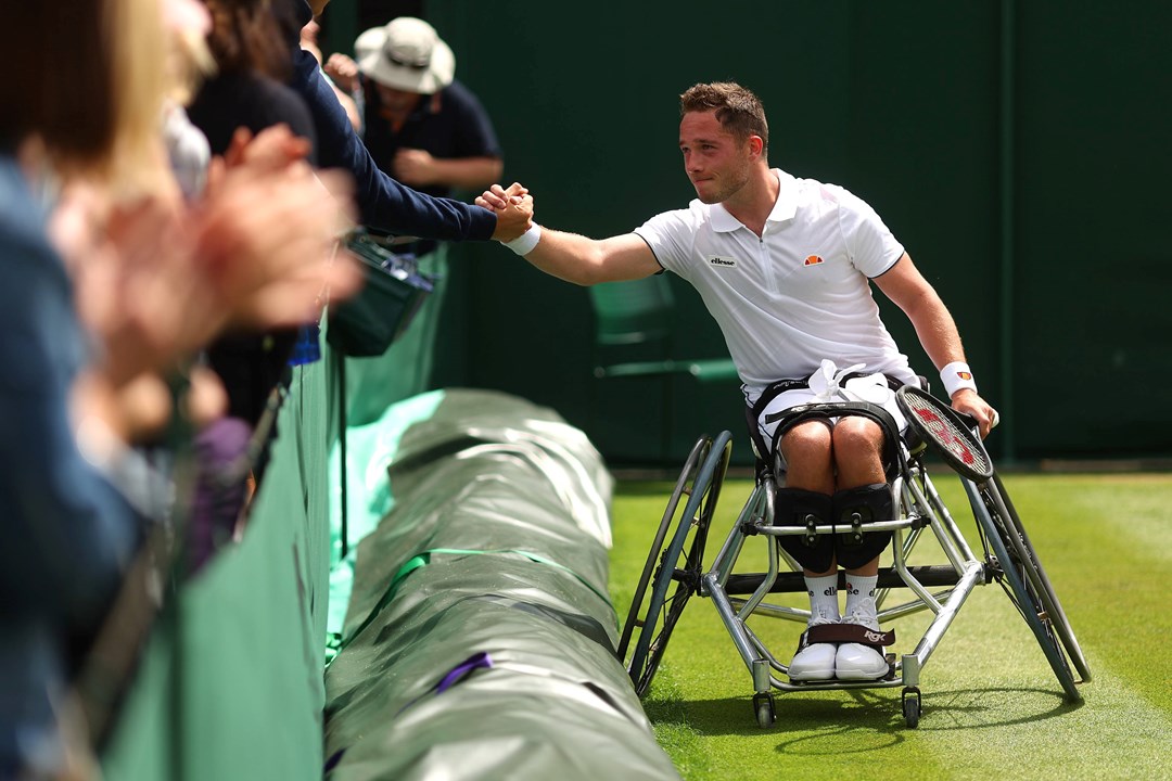 Alfie Hewett shakes hands with the crowd after winning match point against Gordon Reid during their Men's Wheelchair singles Quarter-Finals on day eleven of The Championships Wimbledon 2022 