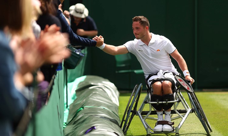 Alfie Hewett shakes hands with the crowd after winning match point against Gordon Reid during their Men's Wheelchair singles Quarter-Finals on day eleven of The Championships Wimbledon 2022 