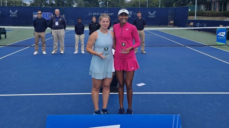 Sarah Beth Grey stood next to Rutuja Bhosale on court holding their winners trophies