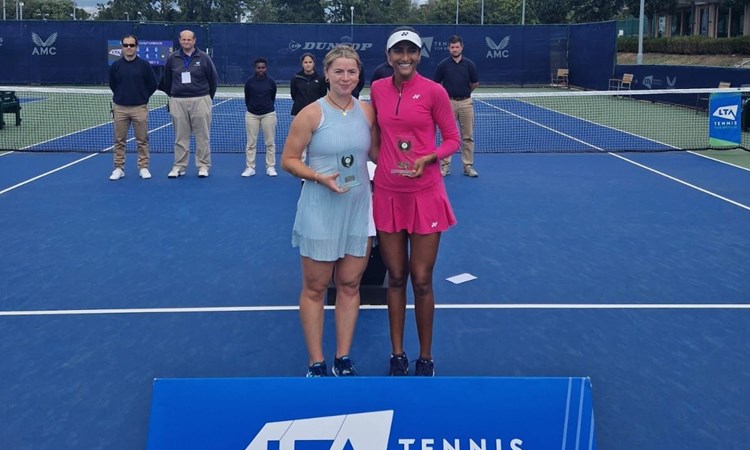 Sarah Beth Grey stood next to Rutuja Bhosale on court holding their winners trophies