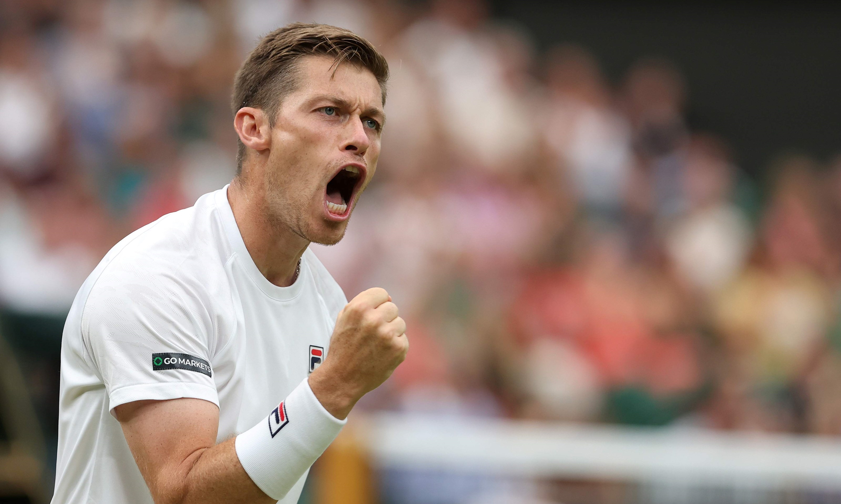 Neal Skupski clenching his fist on court at the Wimbledon final