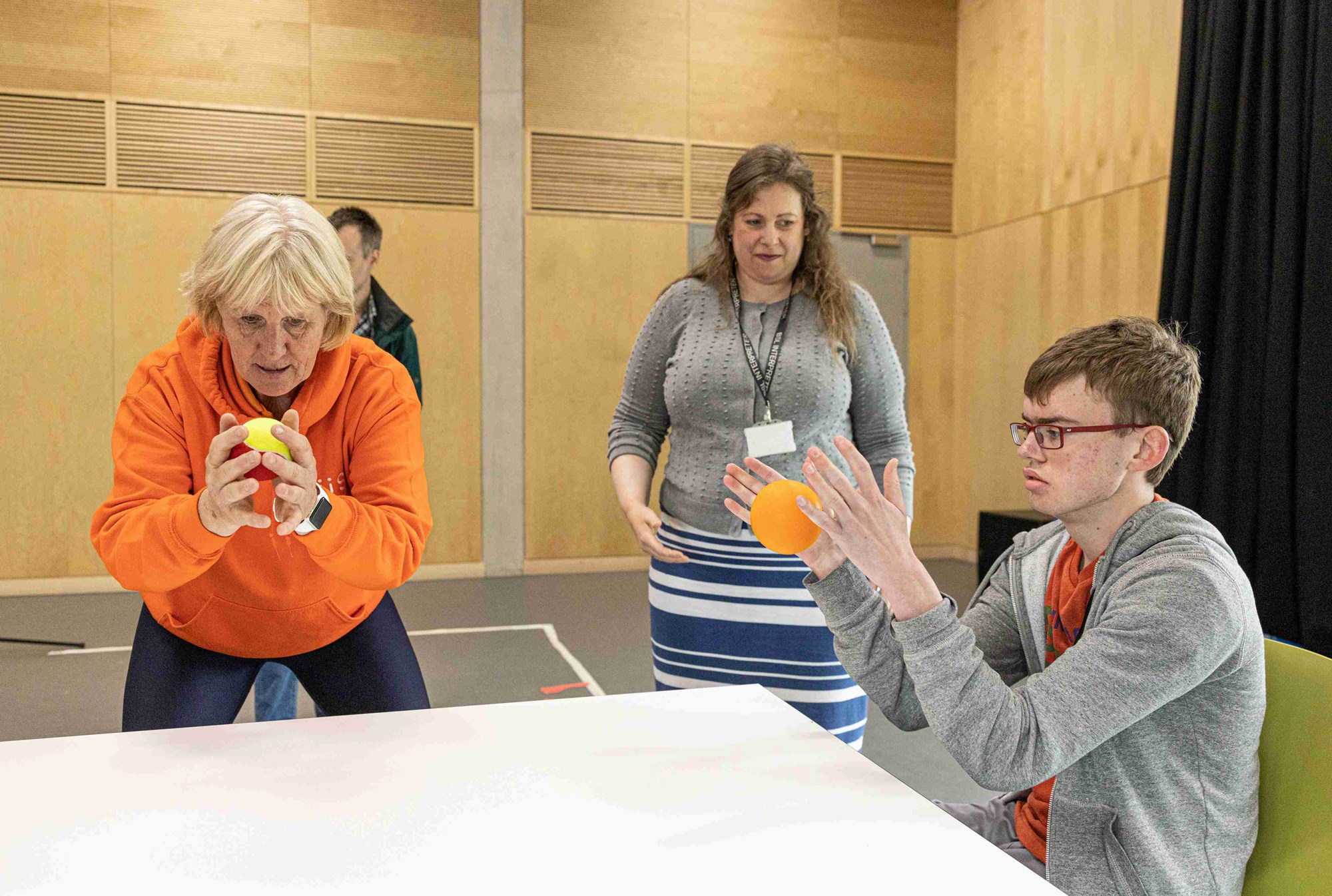 A sensory tennis participant catching a ball.