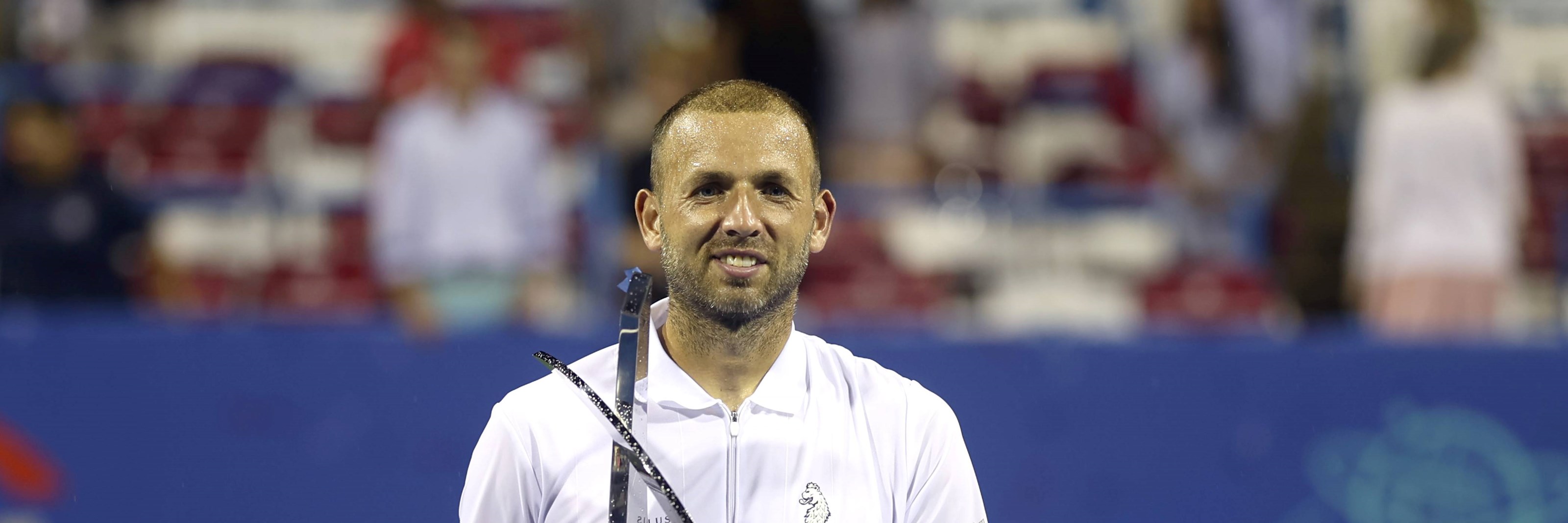 Dan Evans holding the 2023 Citi Open title