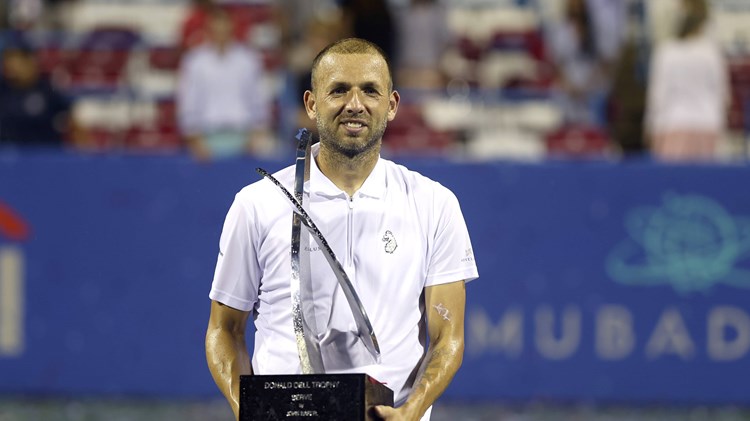 Dan Evans holding the 2023 Citi Open title