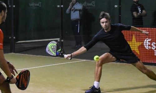 two players on court playing a padel match