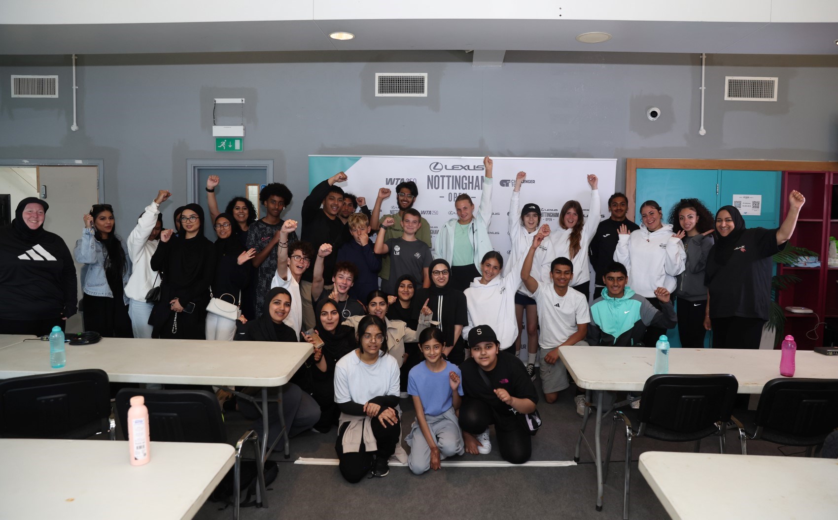 Player with group of children with hands in air