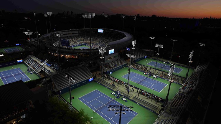 Four tennis courts surrounding Arthur Ashe Stadium at the US Open complex