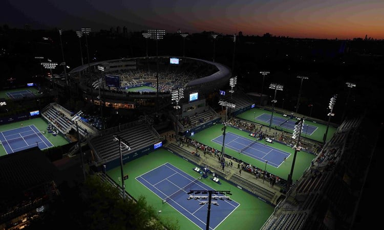 Four tennis courts surrounding Arthur Ashe Stadium at the US Open complex