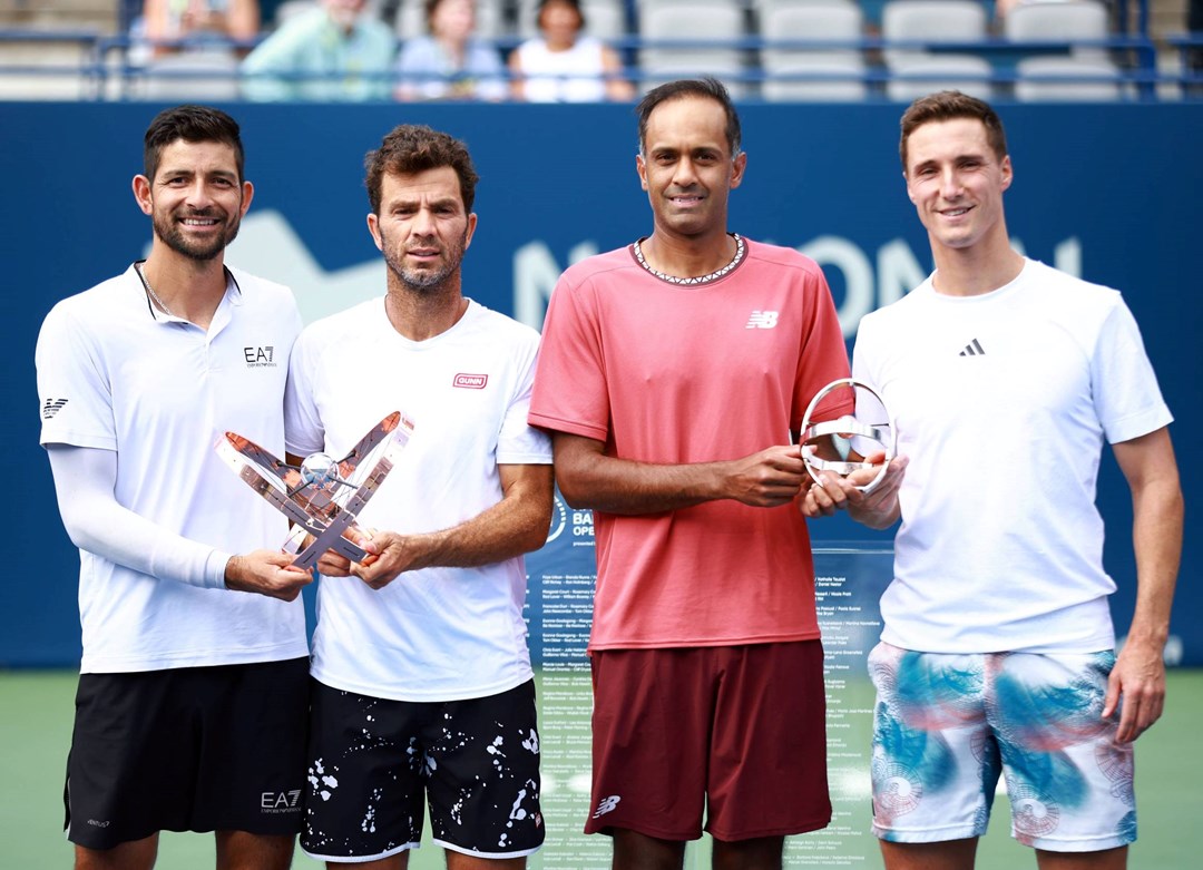 Joe Salisbury & Rajeev Ram holding the National Bank Open runners-up trophy next to champions Marcelo Arevalo & Jean-Julien Rojer