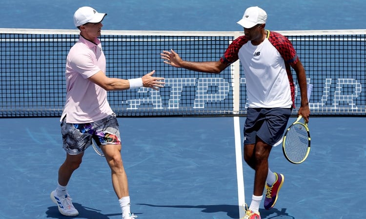 Joe Salisbury and Rajeev Ram interacting during their second round match at the Western & Southern Open 2022