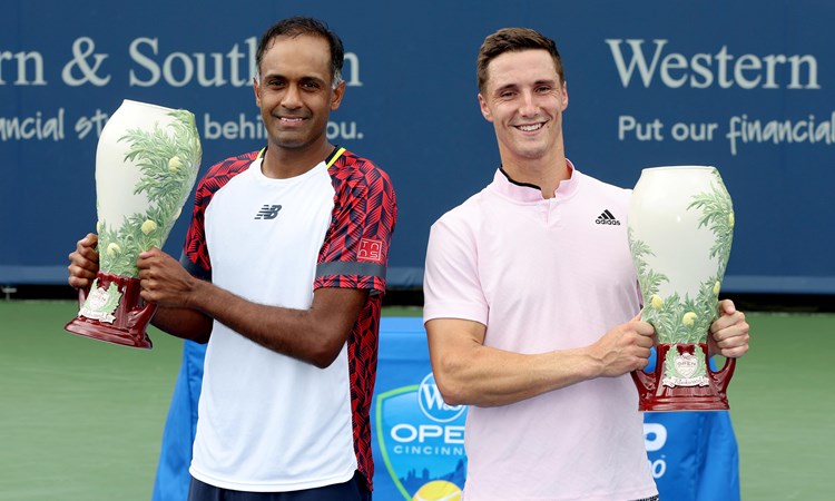 Rajeev Ram and Joe Salisbury pose for photographers after the men's doubles final of the Western & Southern Open at Lindner Family Tennis Center