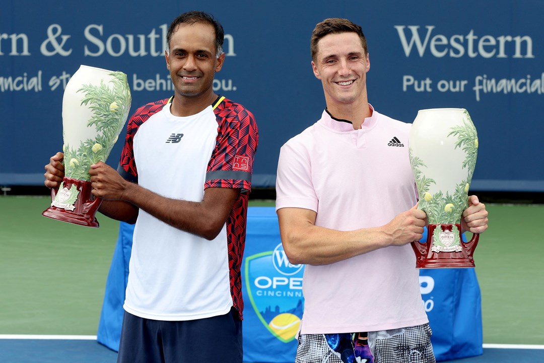 Rajeev Ram and Joe Salisbury pose for photographers after the men's doubles final of the Western & Southern Open at Lindner Family Tennis Center