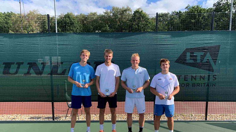 Johannus Monday and Emile Hudd holding their championship trophies next to Anton Matusevich and Arthur Fery at the M25 Aldershot event