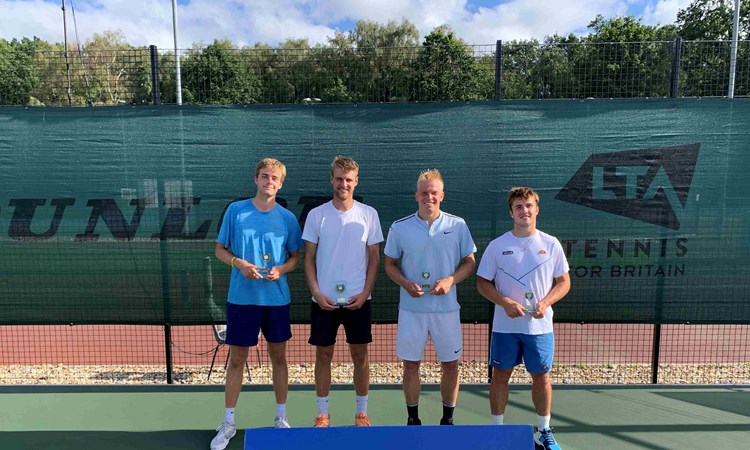 Johannus Monday and Emile Hudd holding their championship trophies next to Anton Matusevich and Arthur Fery at the M25 Aldershot event