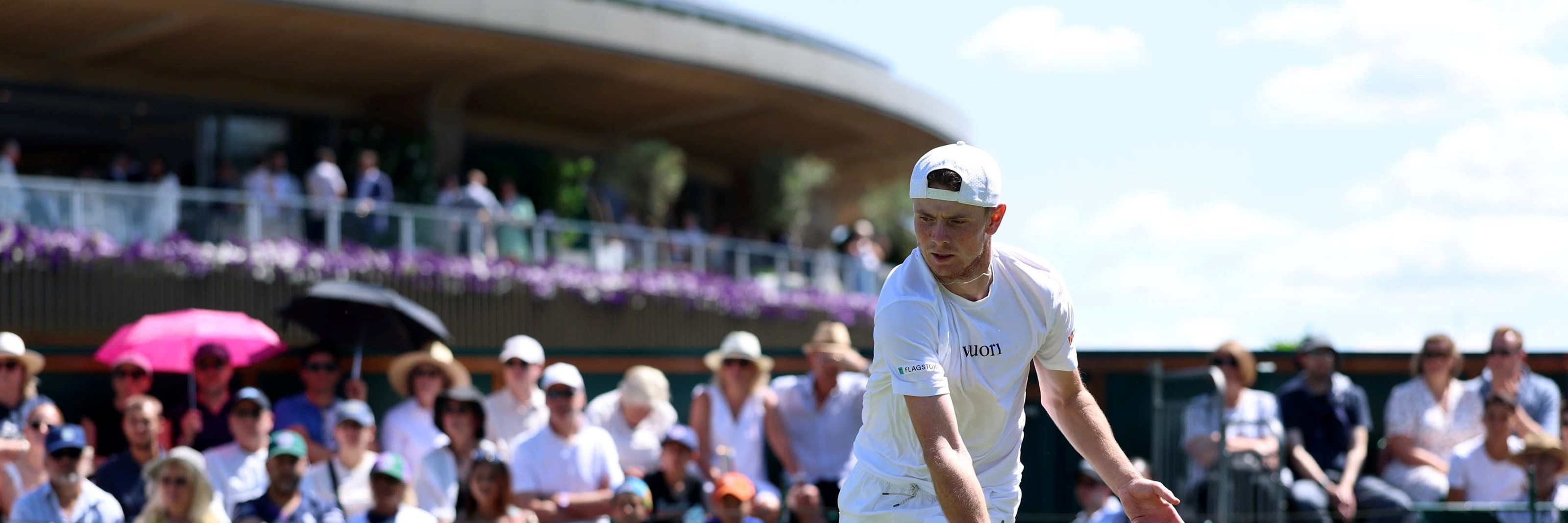 Jack Pinnington Jones hitting a backhand on court at Wimbledon