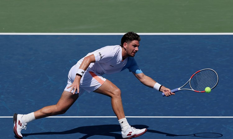 Cam Norrie stretches to hit a forehand in the first round of the 2025 US Open
